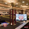 A four post trophy with gold cup.