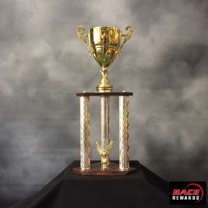 A tree post gold trophy with cup.