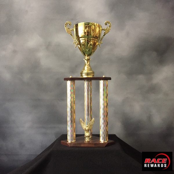 A tree post gold trophy with cup.